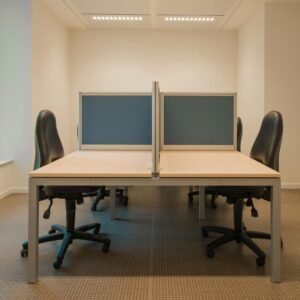 Contemporary office space featuring partitioned desks and ergonomic chairs.