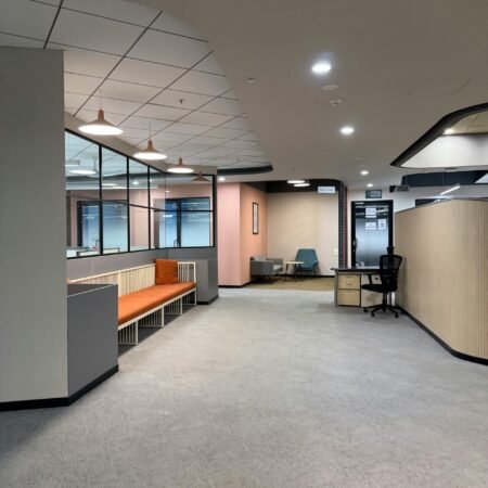 Spacious office interior with modern furnishings and neutral tones.