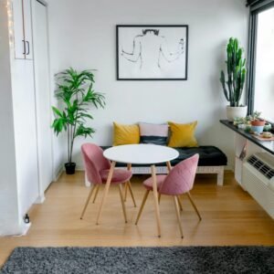 Contemporary living room featuring stylish furniture, artwork, and lush greenery.